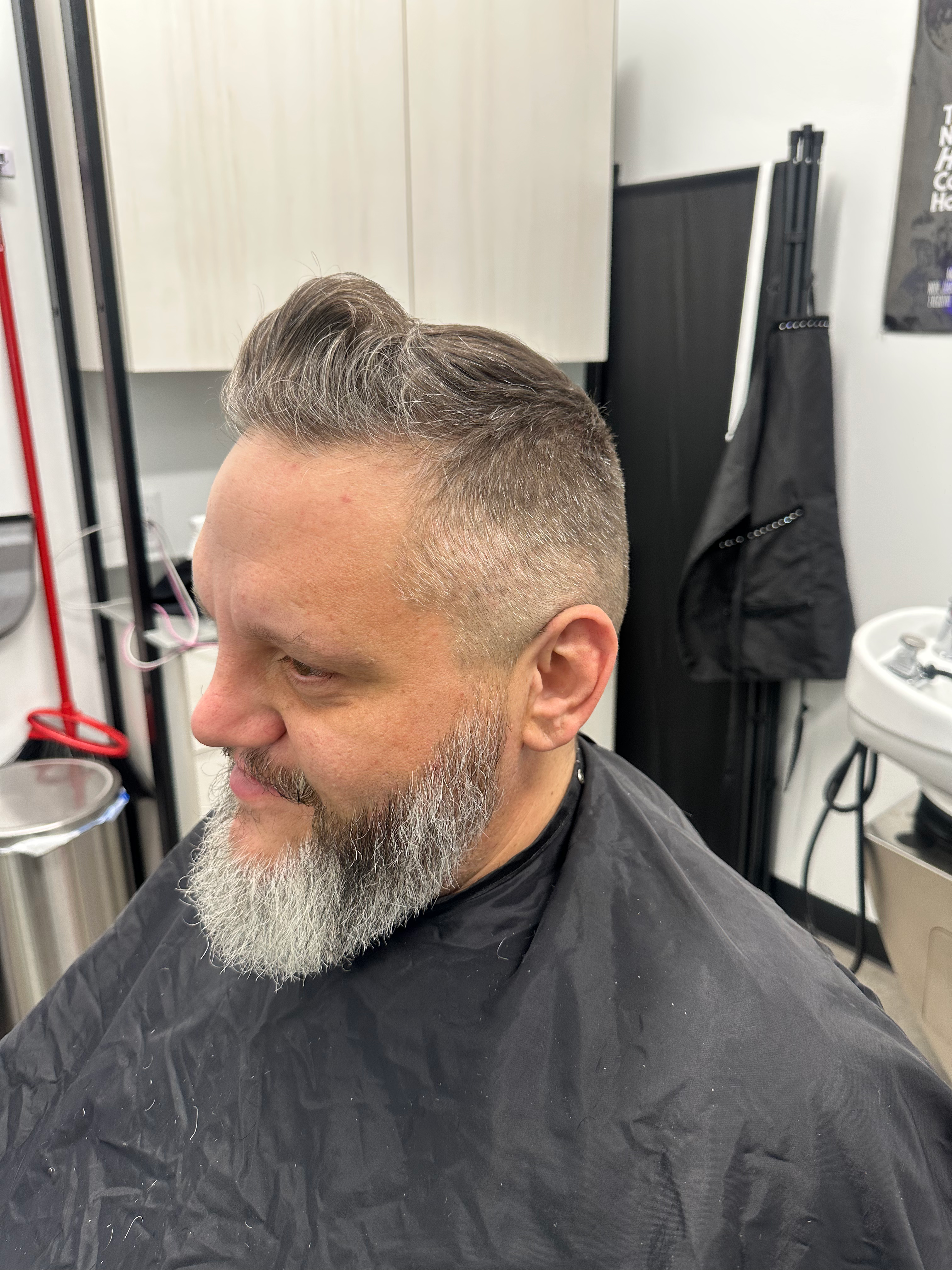 Satisfied client with grey beard and styled hair